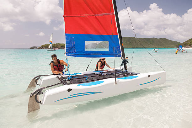 istock young couple taking off in catamaran for a sail 495978710