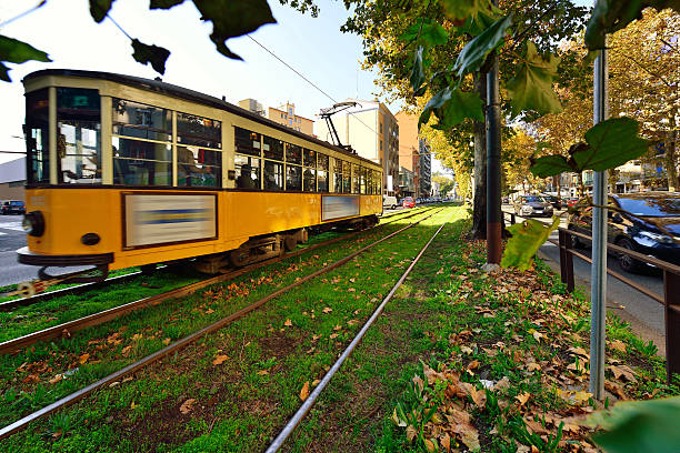 Classic Old Tram, Milan, Italy Classic old tram and city street, Milan, Italy. blurred motion street car green stock pictures, royalty-free photos & images