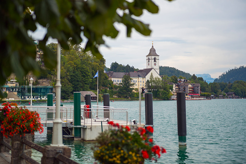Velden, Carinthia, Austria - July 25, 2022: View from the small village Velden to the lake Woerthersee in Austria