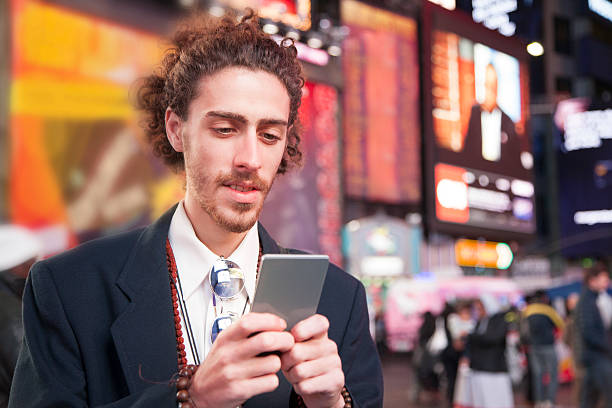istock Man with cell phone in Times Square, New York City. 495983112