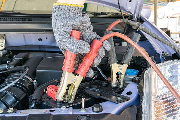 istock automotive technician charging vehicle battery 495983206
