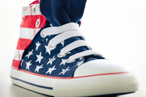 Close up of a right shoe printed, in the colours of the American flag with white background