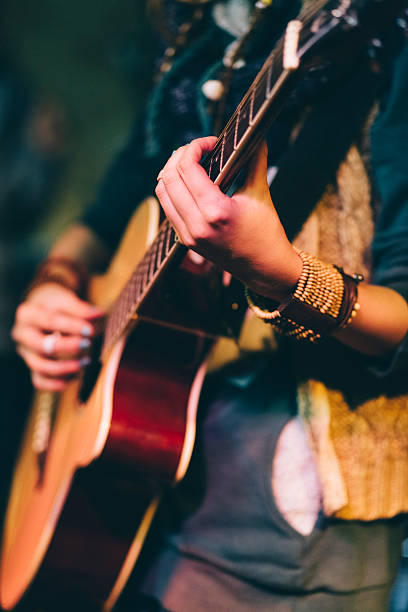 Guitar performance Girl holding a guitar acoustic guitar stock pictures, royalty-free photos & images