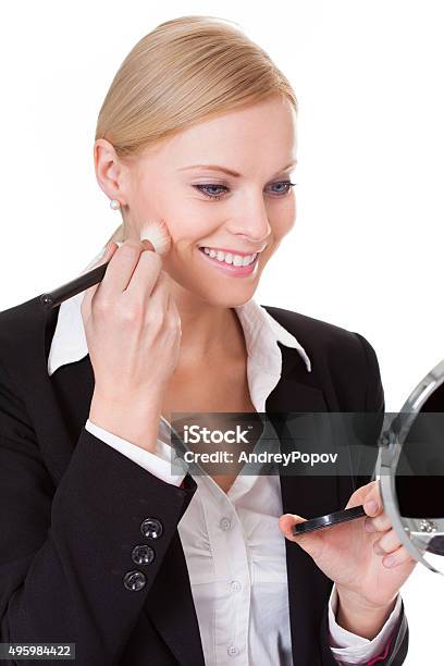 Attractive Businesswoman Applying Foundation Stock Photo - Download Image Now - 2015, Adult, Applying