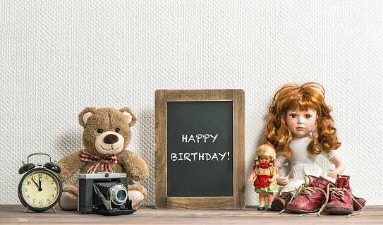 Doll, Teddy Bear, chalkboard and vintage toys. Happy Birthday
