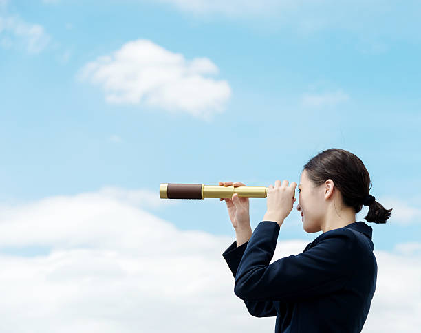 istock Businesswoman with telescope 495986736