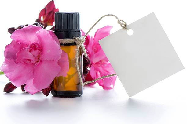 Essential oil, empty tags and roses flowers
