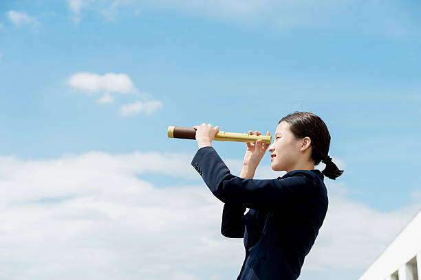 istock Businesswoman with telescope 495986806