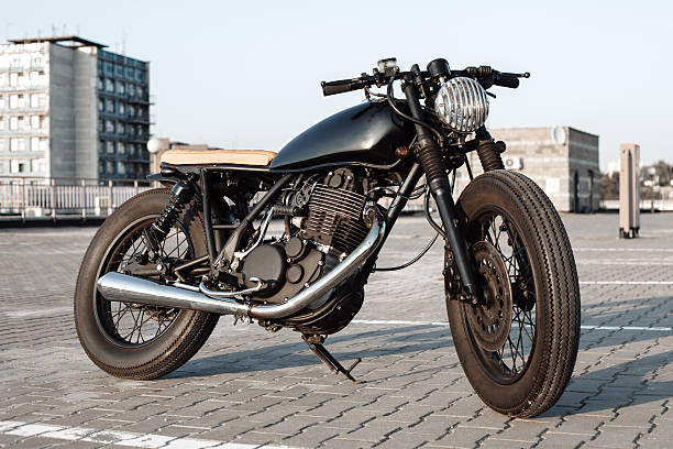 istock Vintage motorcycle in parking lot during sunset 495988366