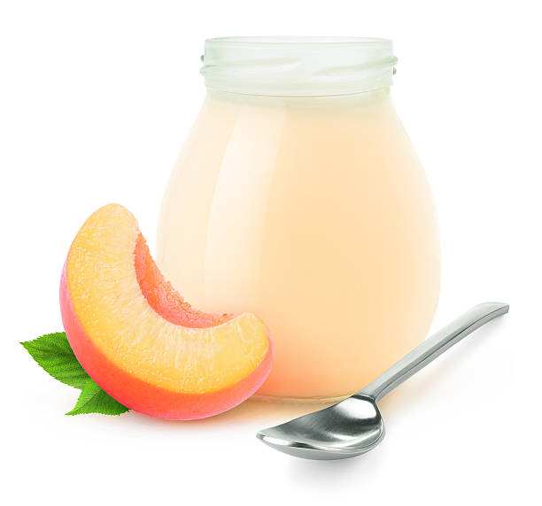 istock Glass jar of peach yogurt isolated on white 495988986