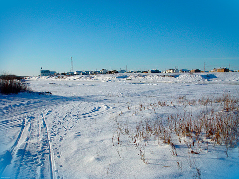 Standing on the Attawapiskat river in January. View of the community.