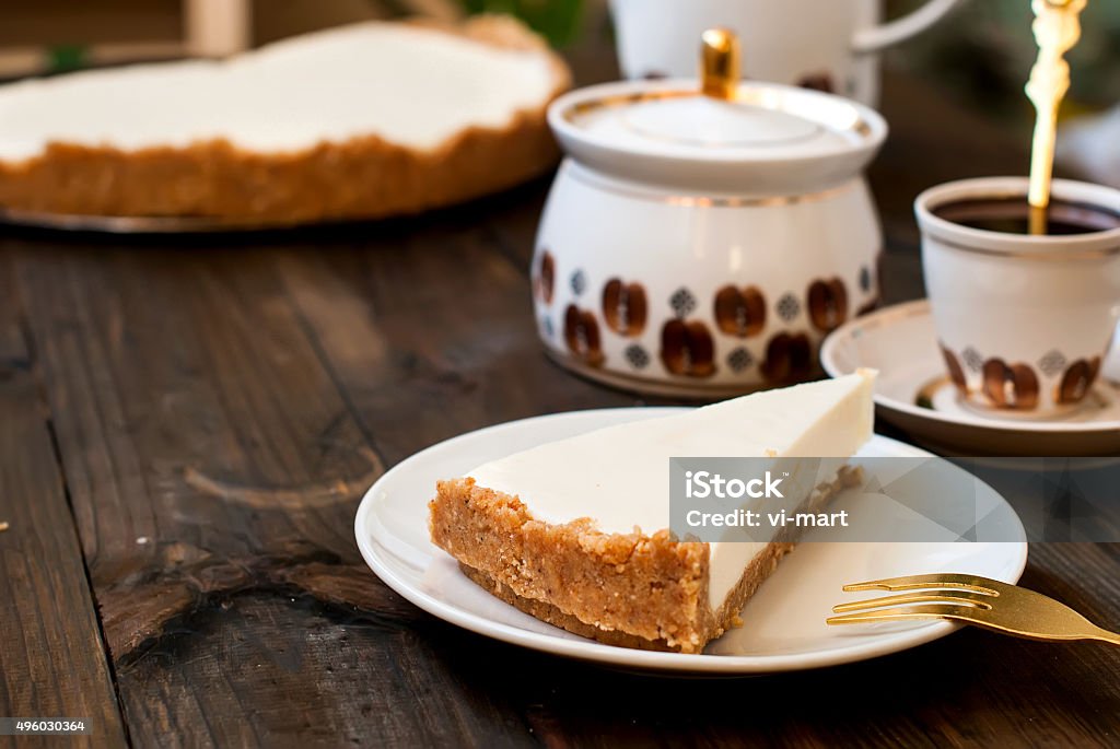 cheesecake and a cup of coffee, slice of cheesecake and a cup of black coffee for breakfast, a wooden background, top view 2015 Stock Photo