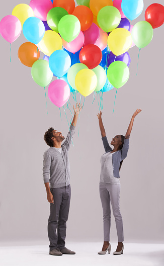 Studio shot of a young couple releasing a big bunch of balloons into the airhttp://195.154.178.81/DATA/i_collage/pi/shoots/783387.jpg