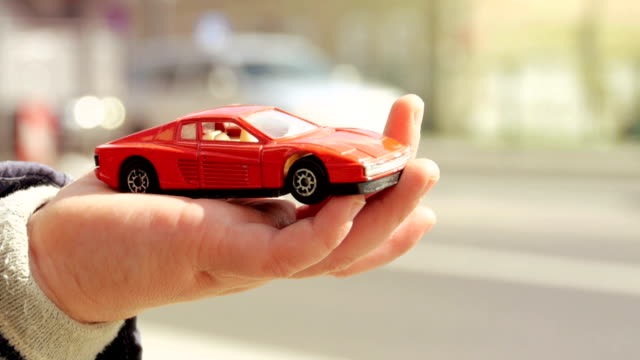 Car toy in baby hand