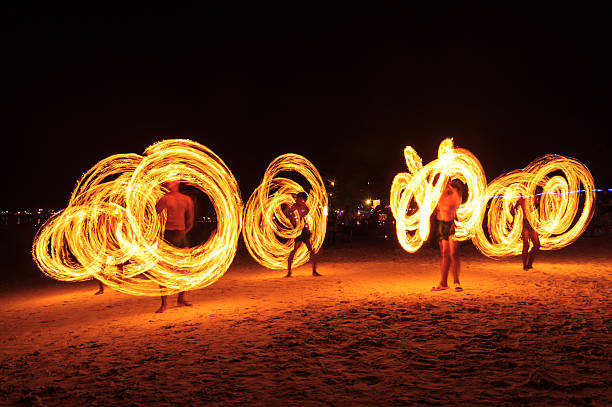 Strong Men Juggling Fire in Thailand Strong Men Juggling Fire in Thailand - Fire Dancers hula dancer stock pictures, royalty-free photos & images