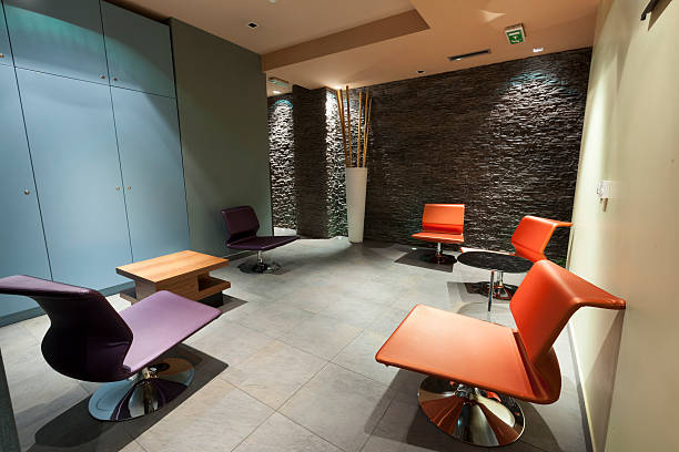 istock Modern waiting room with stone wall and colorful chairs 496033407