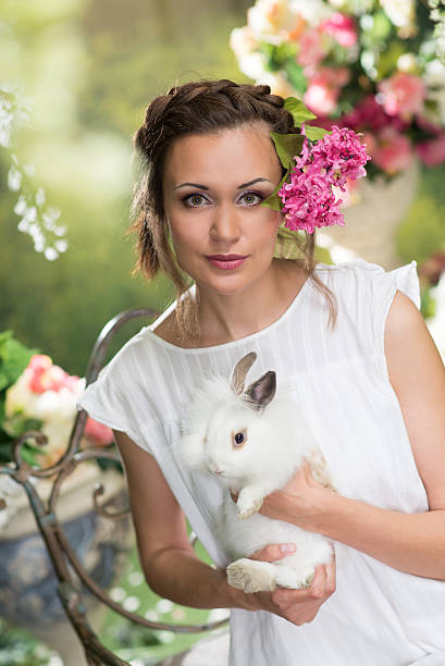 istock Woman with rabbit in summer garden 496033635