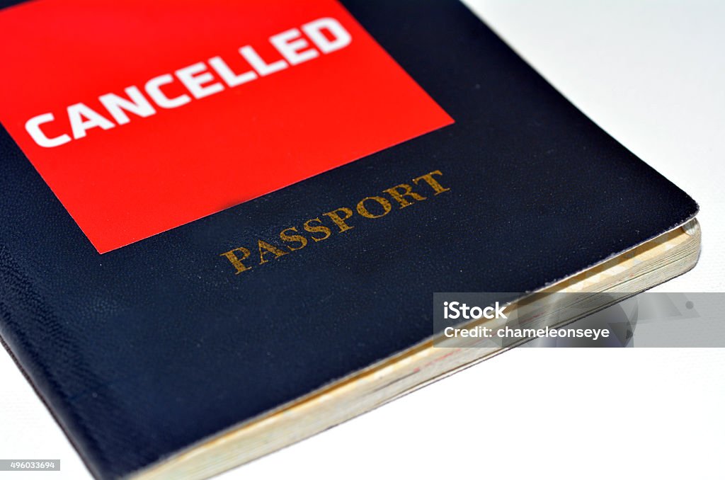 Cancelled Passport Cancelled passport isolated on white background. Concept photo of human identity and Freedom of Movement 2015 Stock Photo