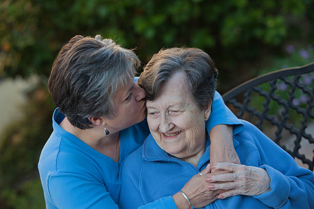 istock Daughter Kisses Mothers Forehead 496034142