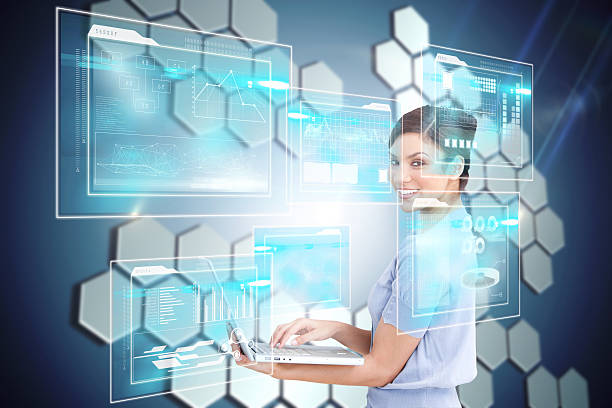 istock Happy businesswoman using laptop with interfaces 496034797