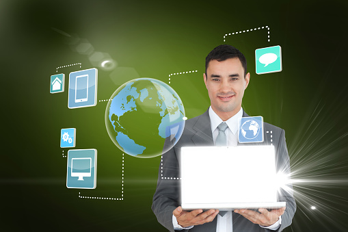 Digital composite of handsome businessman showing laptop with earth interface