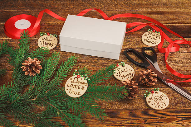 istock White gift box with red bow on Christmas wooden background 496034984