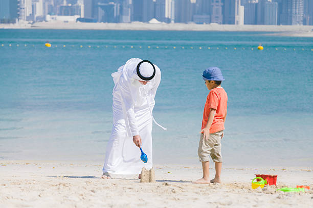 istock Grandfather and little boy playing on the beach 496036830