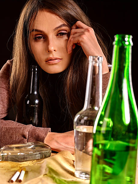 istock Drunk girl holding bottle of vodka 496036832