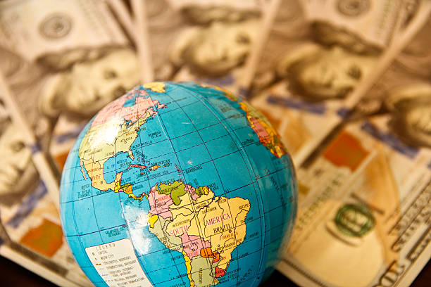 istock US Dollar currency and world globe 496036937