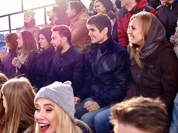 istock Sport fans clapping and singing on tribunes 496037360