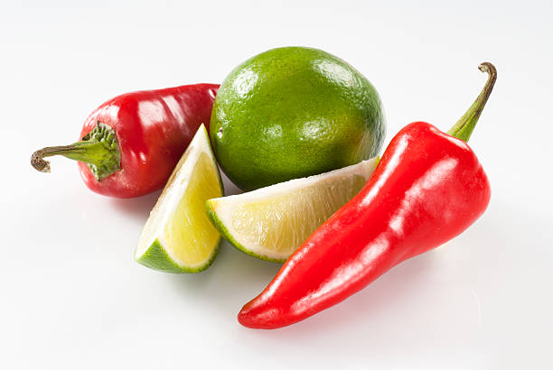 Jalapeño pepper and limes isolated on a white background