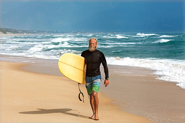 istock Surfer at the sea is standing with a surf board 496038082