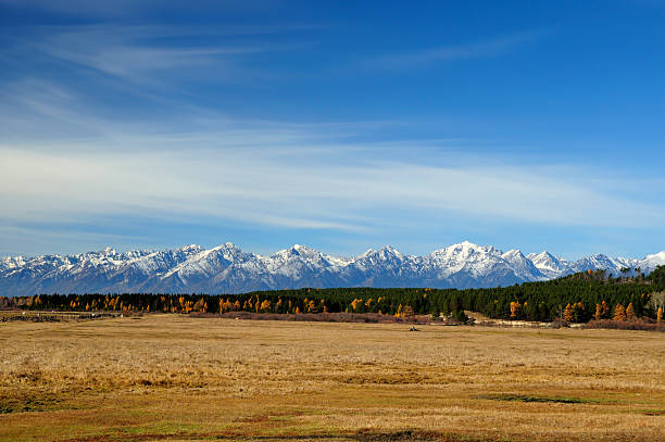 istock blue sky over the vast steppes,, mountains covered with snow, 496039632