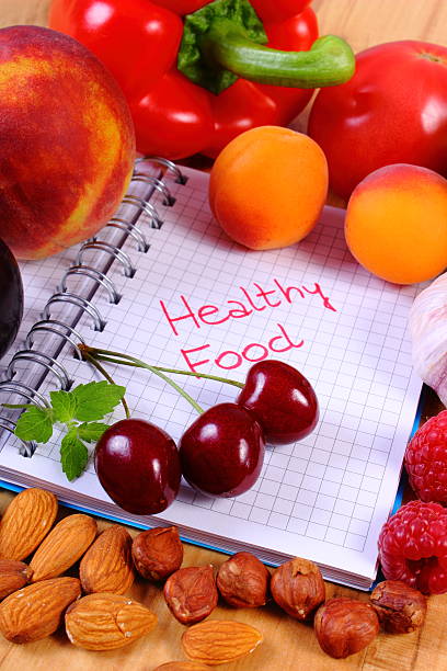 istock Fruits and vegetables with notebook, slimming and healthy food 496064134