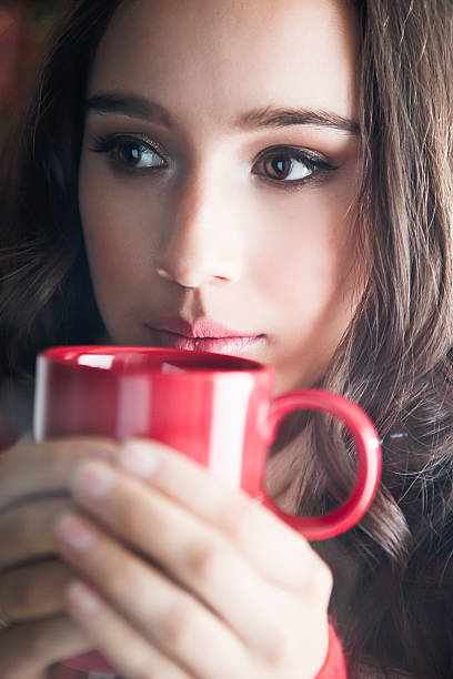 istock Beautiful young woman drinking coffee 496065330