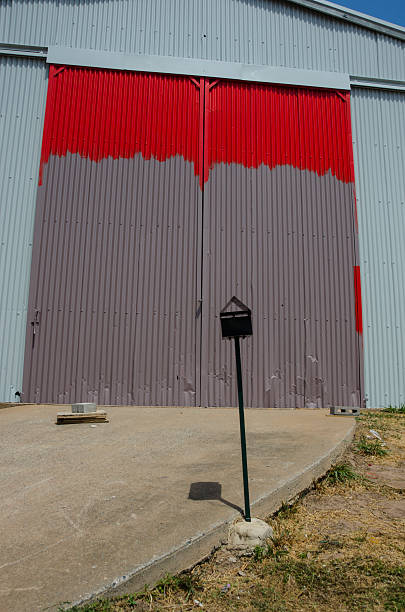 Partly painted vivid red and grey warehouse door stock photo