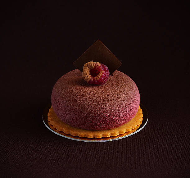 istock Chocolate raspberry cake with tonka beans in a colored glaze. 496066366