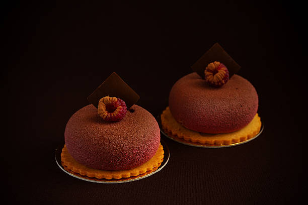istock Chocolate raspberry cake with tonka beans in a colored glaze. 496066380