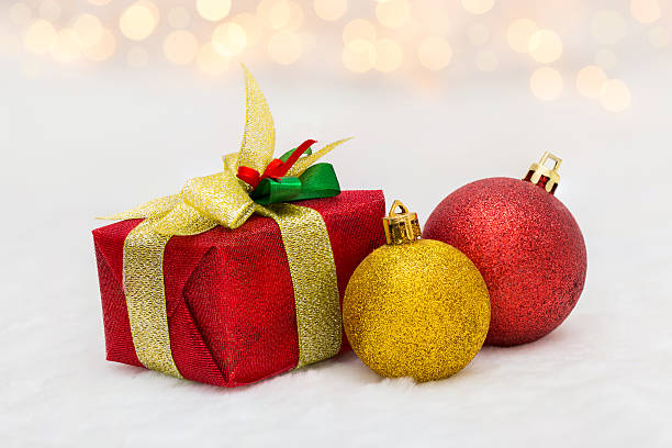 istock Red Christmas gift box with shiny golden ball 496066834