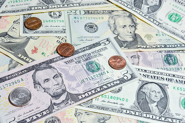 istock American Dollar bills with coins 496068512