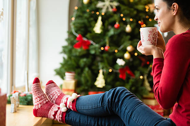 istock Woman drinking hot drink on Christmas day 496069538