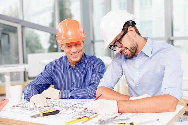 istock Cheerful male engineers projecting the new building 496071510
