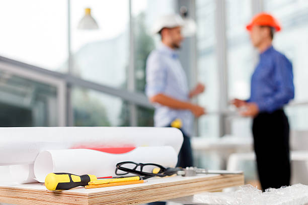 istock Professional male engineers are talking at office 496071782