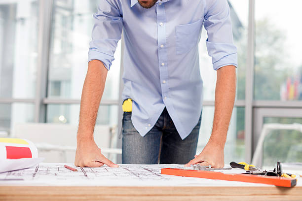 istock Cheerful male architect is working at the office 496071900