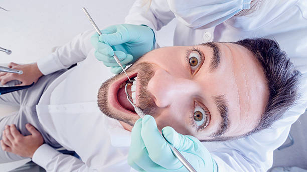 istock Terrified patient at the dentist office 496073102