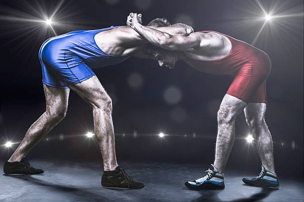istock Two wrestlers in stance on stage 496075032