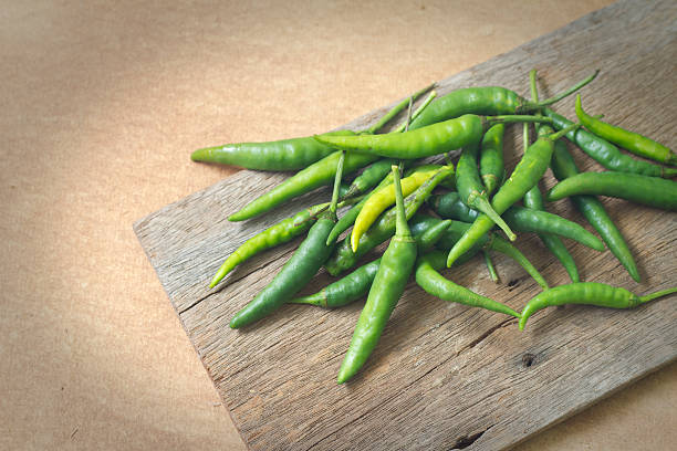 some chili peppers on the old wood stock photo