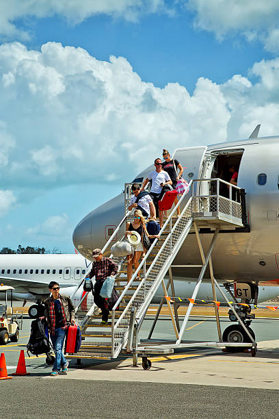 Passenger airplane with a boarding steps in the morning sun