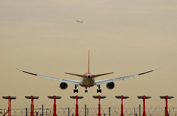 istock Commercial Aircraft Landing over Runway lights 496096446
