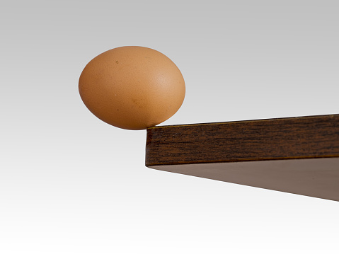 Real egg. Risk, danger concept or metaphor.